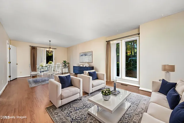 a view of a livingroom with wooden floor and a fireplace