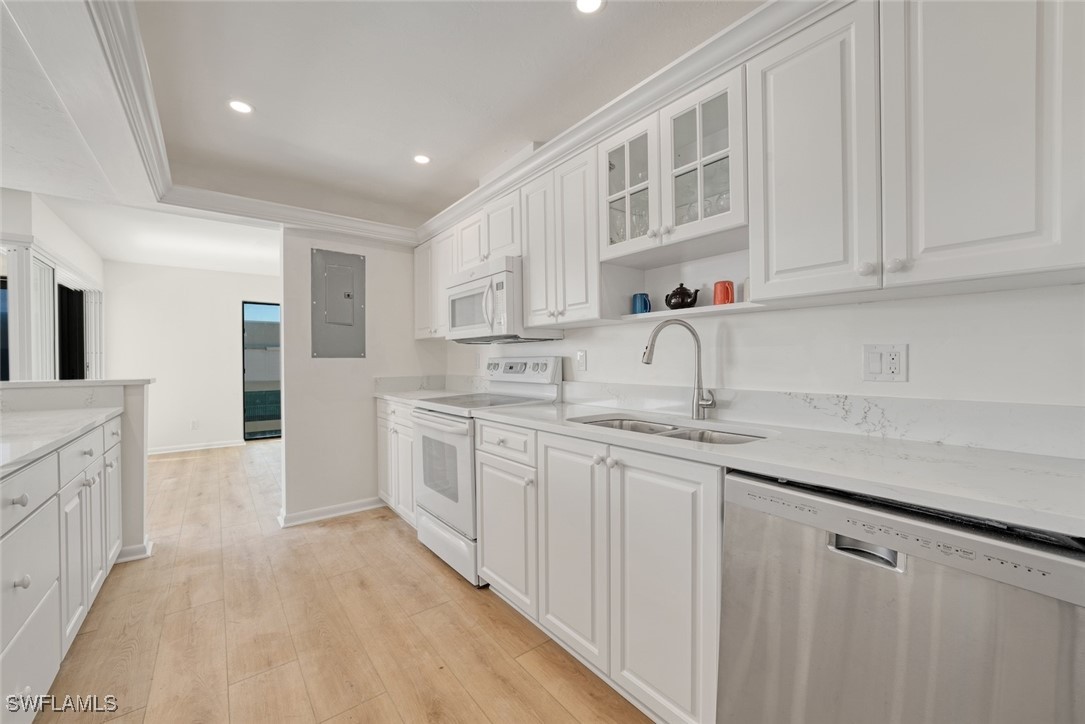 Undisclosed Address Sanibel, FL 33957 - Photo 14 of 30 a kitchen with granite countertop white cabinets and stainless steel appliances