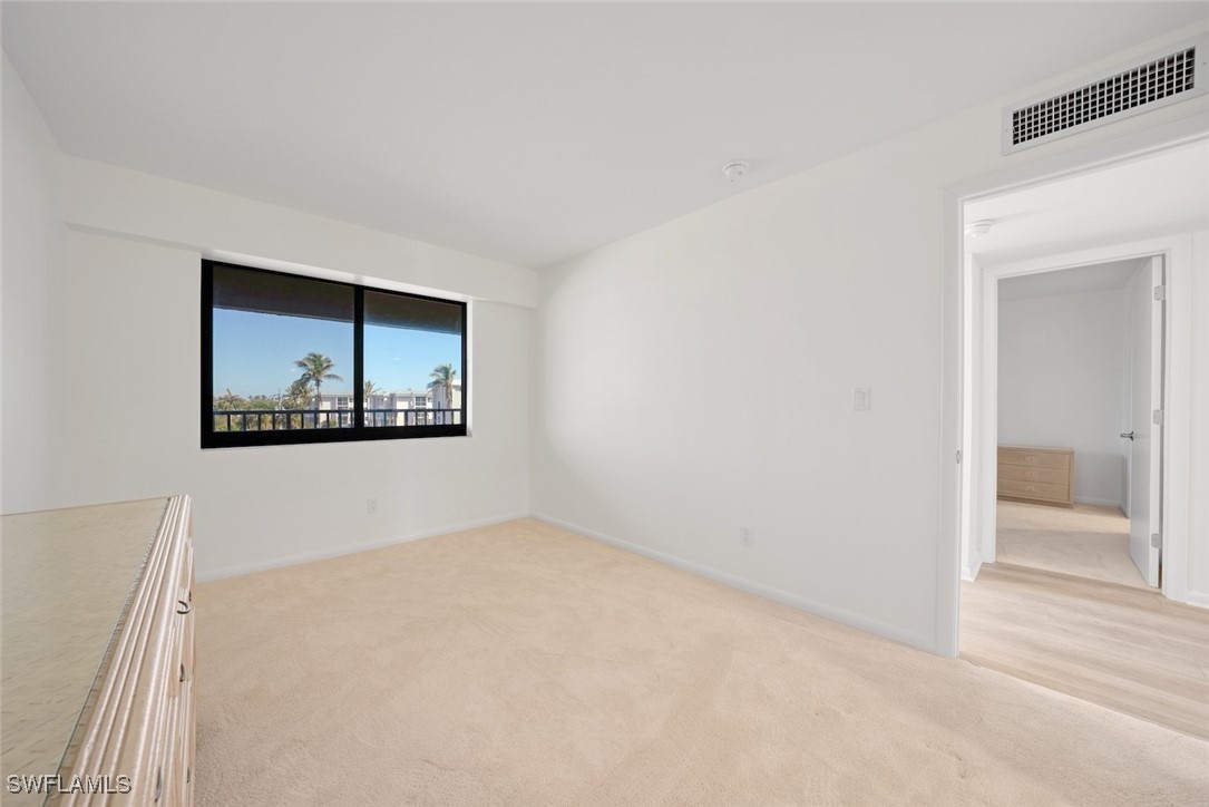 Undisclosed Address Sanibel, FL 33957 - Photo 26 of 30 a view of an empty room with wooden floor and a bathroom