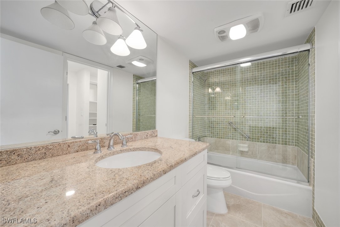 Undisclosed Address Sanibel, FL 33957 - Photo 28 of 30 a bathroom with a granite countertop sink a toilet and bathtub