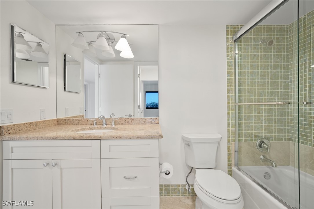 Undisclosed Address Sanibel, FL 33957 - Photo 29 of 30 a bathroom with a granite countertop sink mirror vanity and toilet