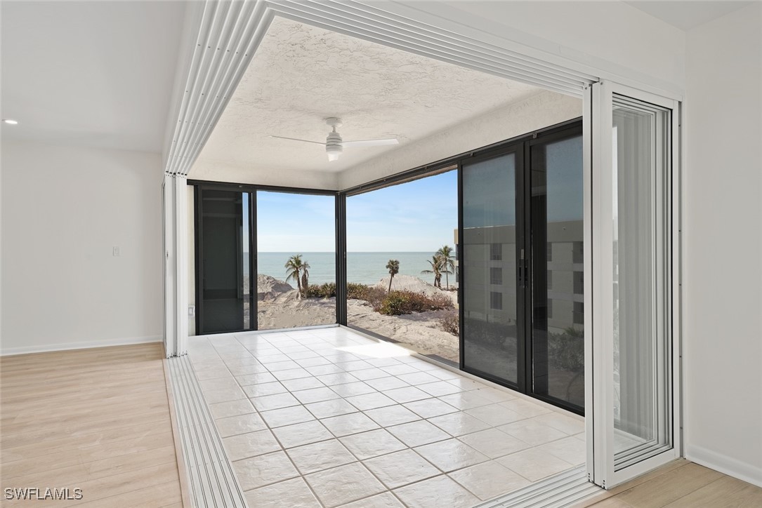 Undisclosed Address Sanibel, FL 33957 - Photo 8 of 30 a large bedroom with a large bed and a chandelier