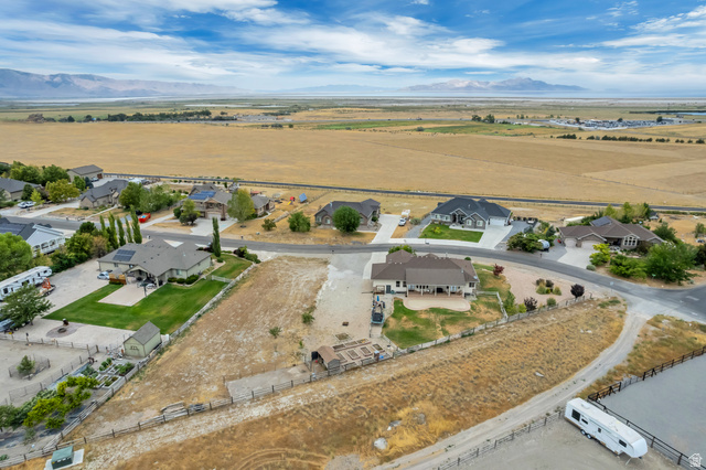 7296 Ridge Road Lake Point, UT 84074 - Photo 52 of 54 Aerial perspective showcasing a residential neighborhood with distant mountain and open field scenery