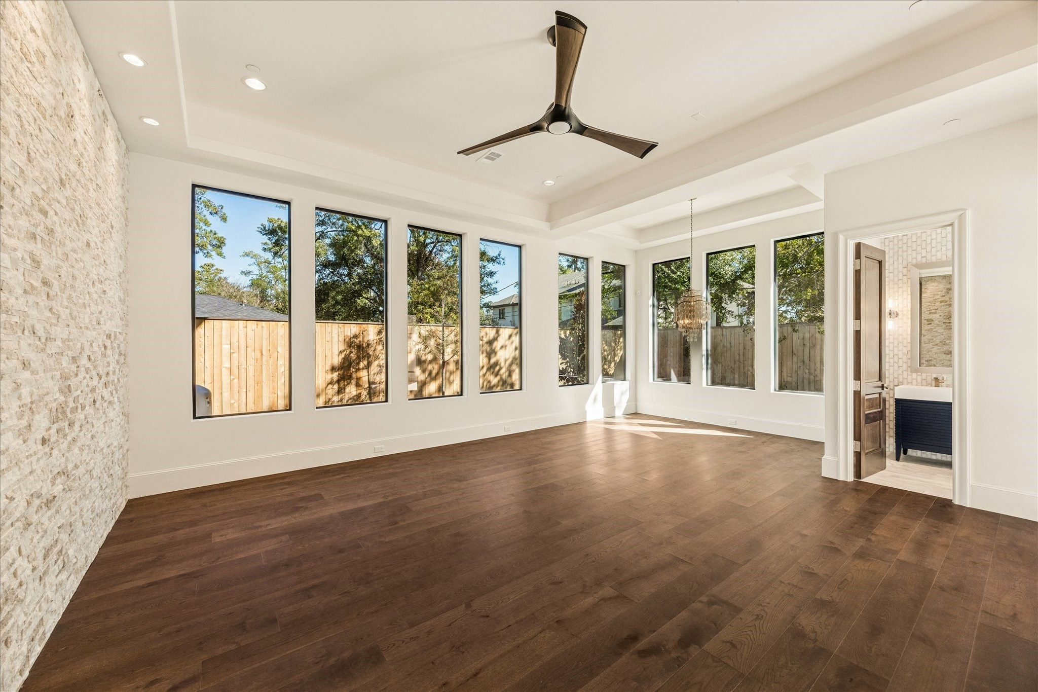318 Knipp Road Houston, TX 77024 - Photo 11 of 44 a view of an empty room with a window and wooden floor