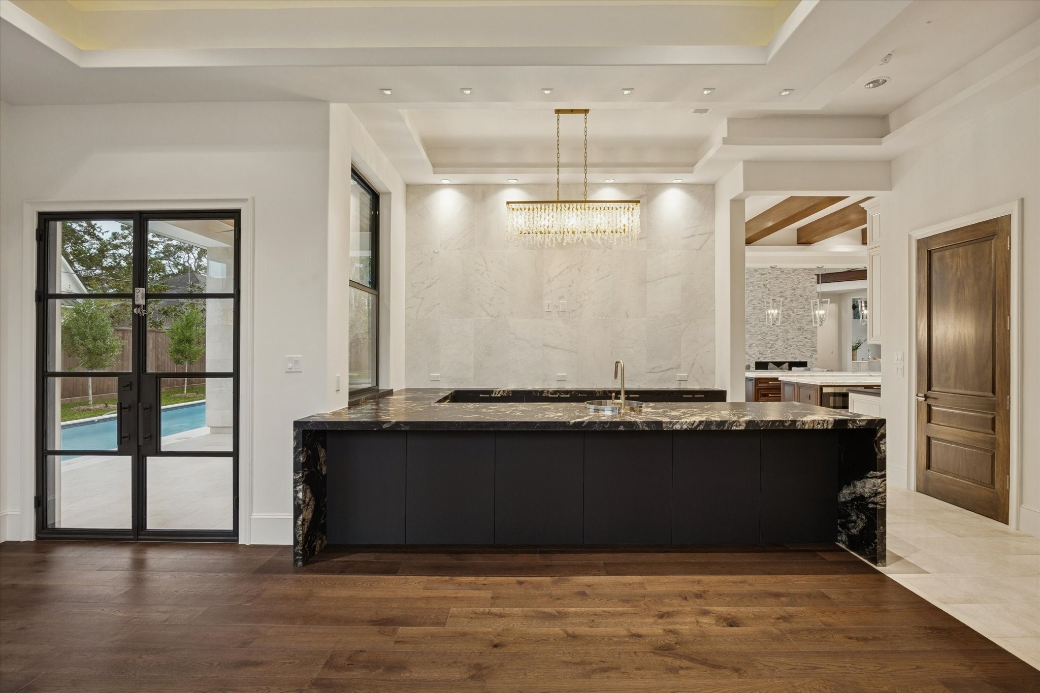 318 Knipp Road Houston, TX 77024 - Photo 14 of 48 a view of a room with kitchen island granite countertop wooden floor and large windows