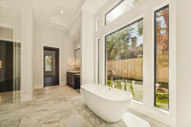a bathroom with a white tub shower and sink