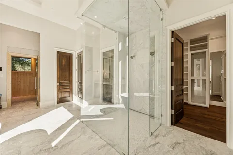 a spacious bedroom with a bed and a walk in closet