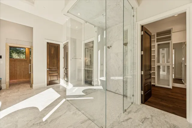 a spacious bedroom with a bed and a walk in closet