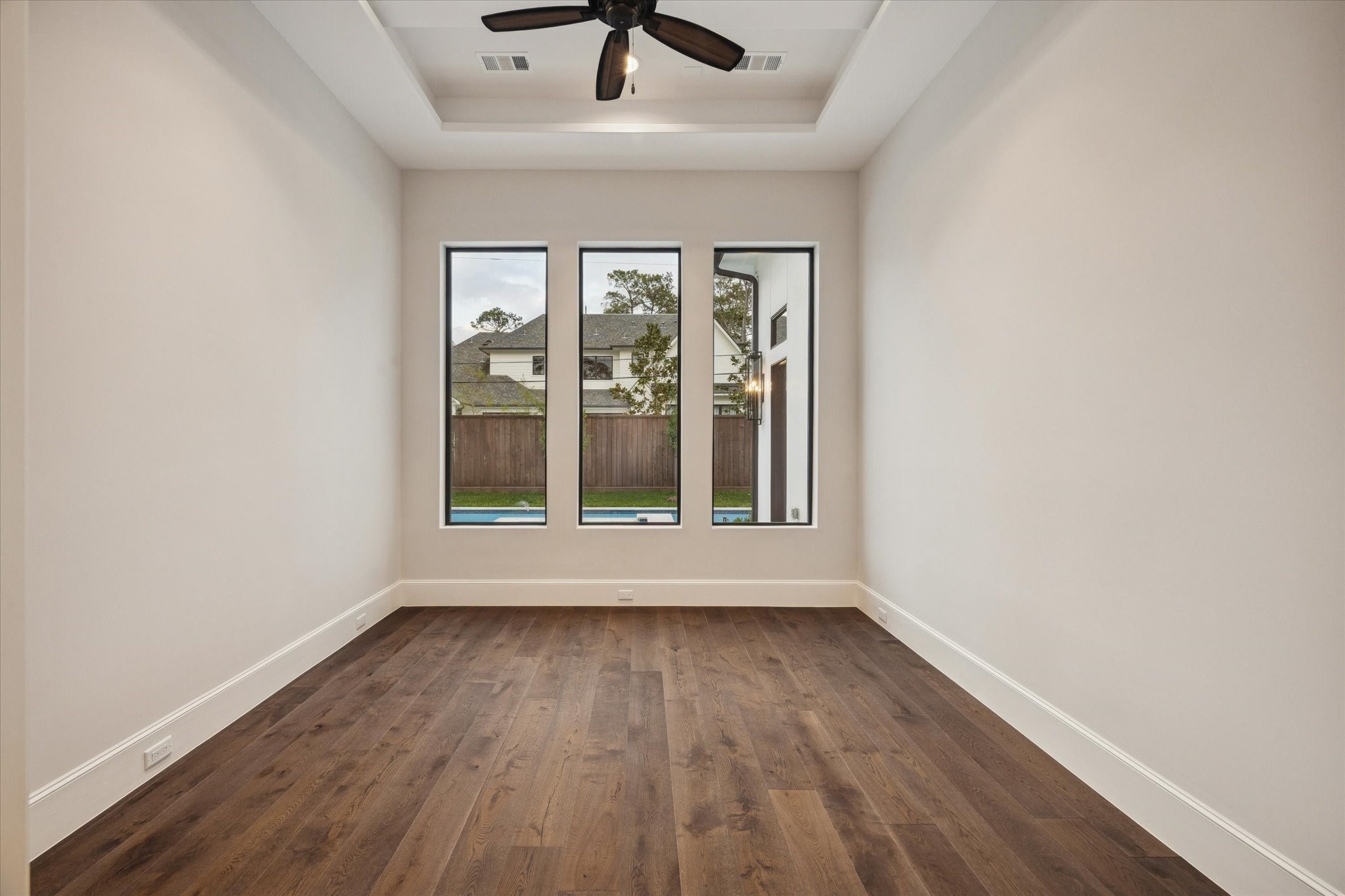 318 Knipp Road Houston, TX 77024 - Photo 20 of 48 an empty room with wooden floor and windows