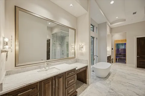 a bathroom with a granite countertop sink a toilet and a mirror