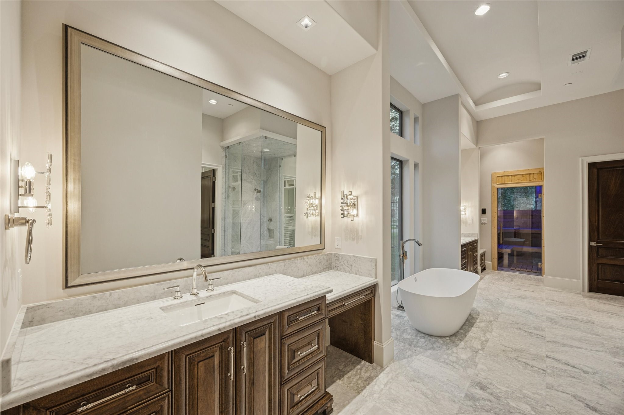 318 Knipp Road Houston, TX 77024 - Photo 22 of 48 a spacious bathroom with a granite countertop sink toilet mirror and bathtub
