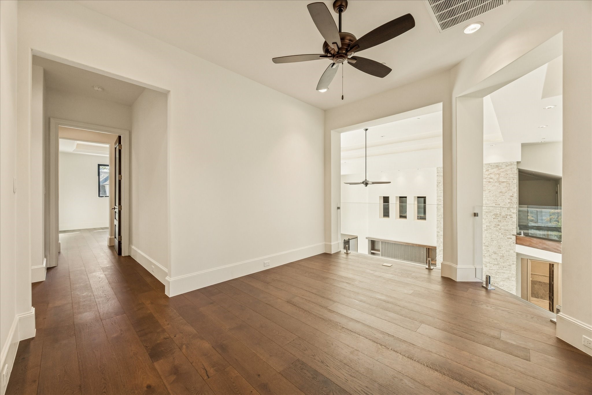 318 Knipp Road Houston, TX 77024 - Photo 26 of 44 a view of a livingroom with wooden floor and a ceiling fan