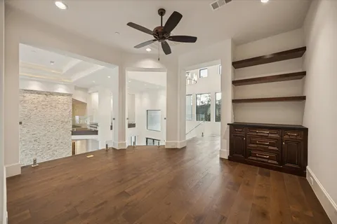 a view of an empty room with window and cabinet