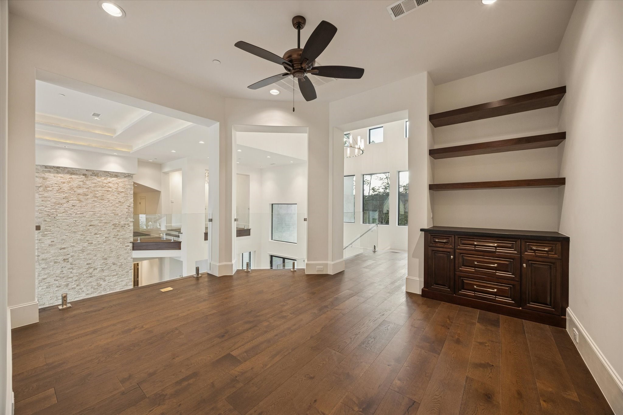 318 Knipp Road Houston, TX 77024 - Photo 27 of 48 a view of an empty room and kitchen with wooden floor