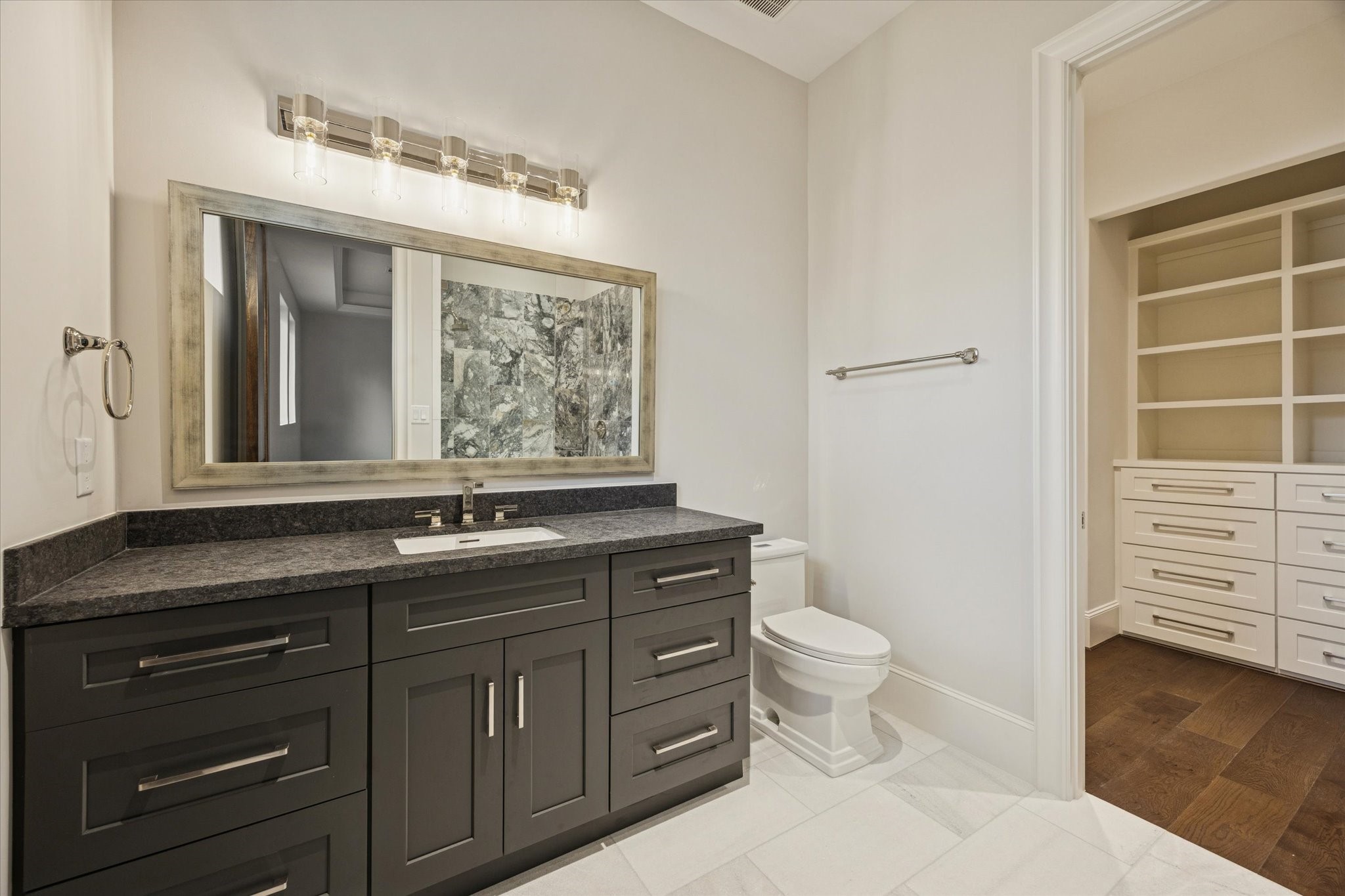 318 Knipp Road Houston, TX 77024 - Photo 29 of 48 a bathroom with a granite countertop toilet sink and mirror