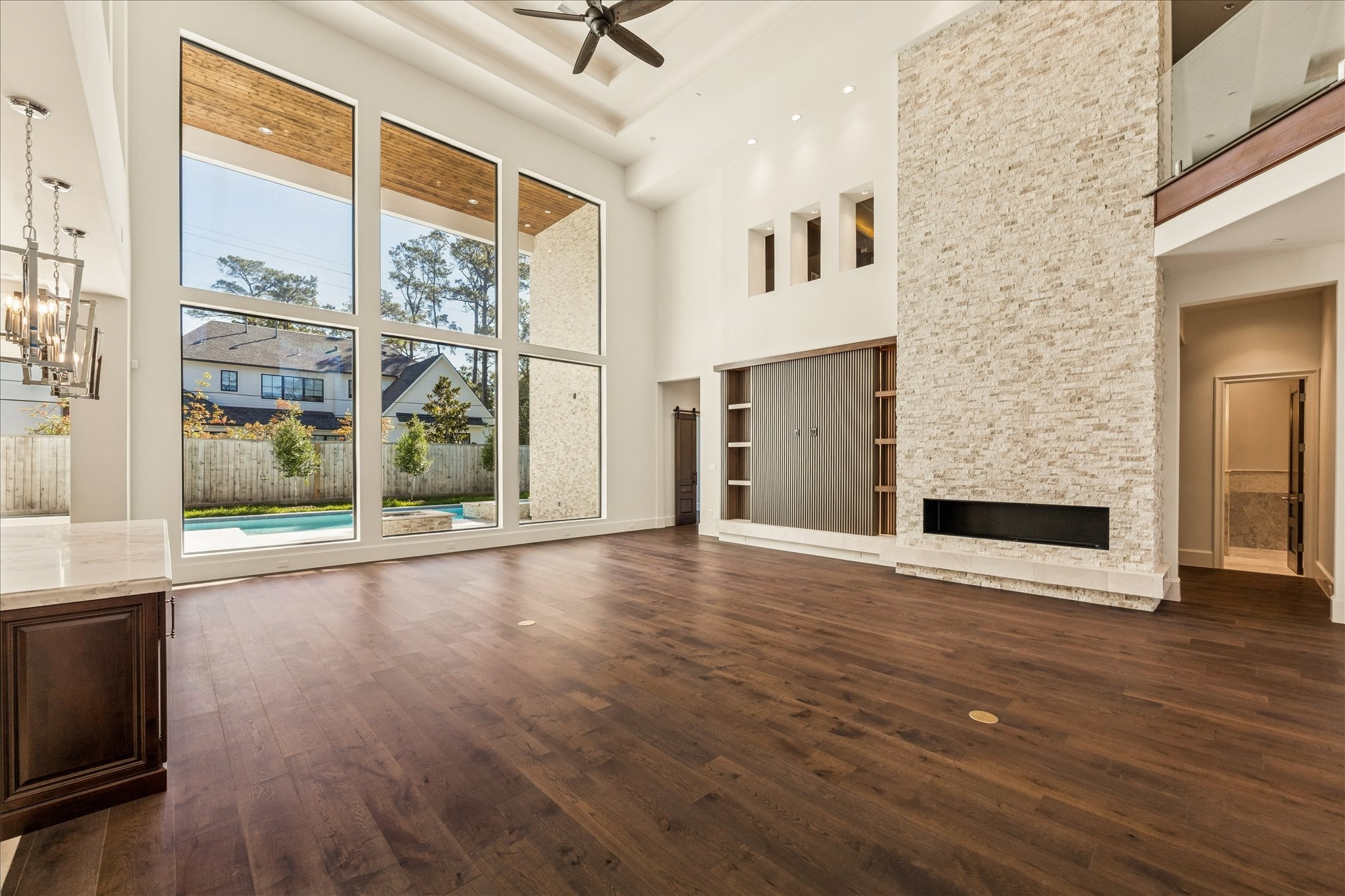 318 Knipp Road Houston, TX 77024 - Photo 3 of 44 a view of an empty room with a window and wooden floor