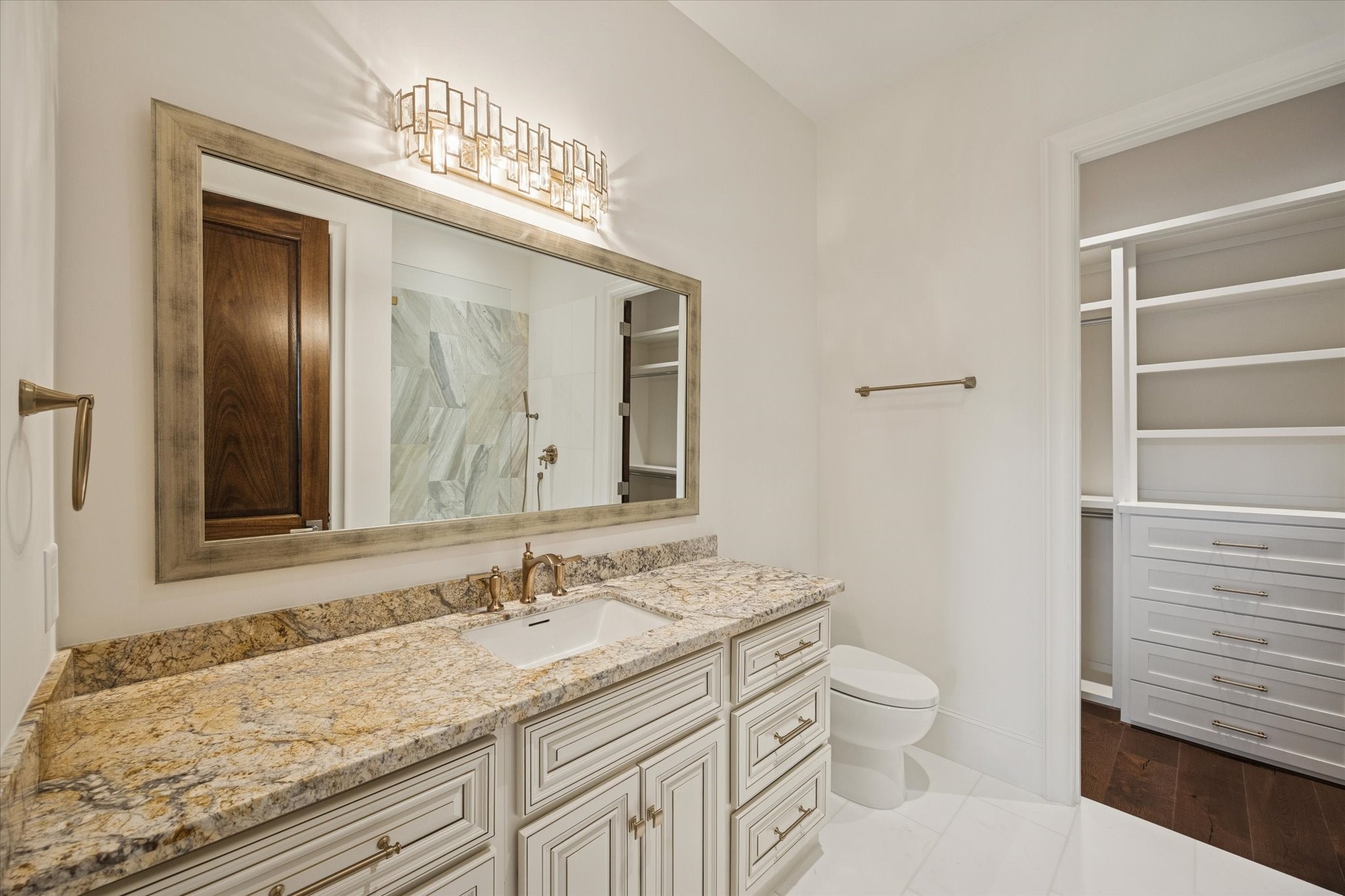 318 Knipp Road Houston, TX 77024 - Photo 31 of 48 a bathroom with a granite countertop sink a toilet and a mirror