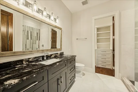 a bathroom with a double vanity sink and a mirror