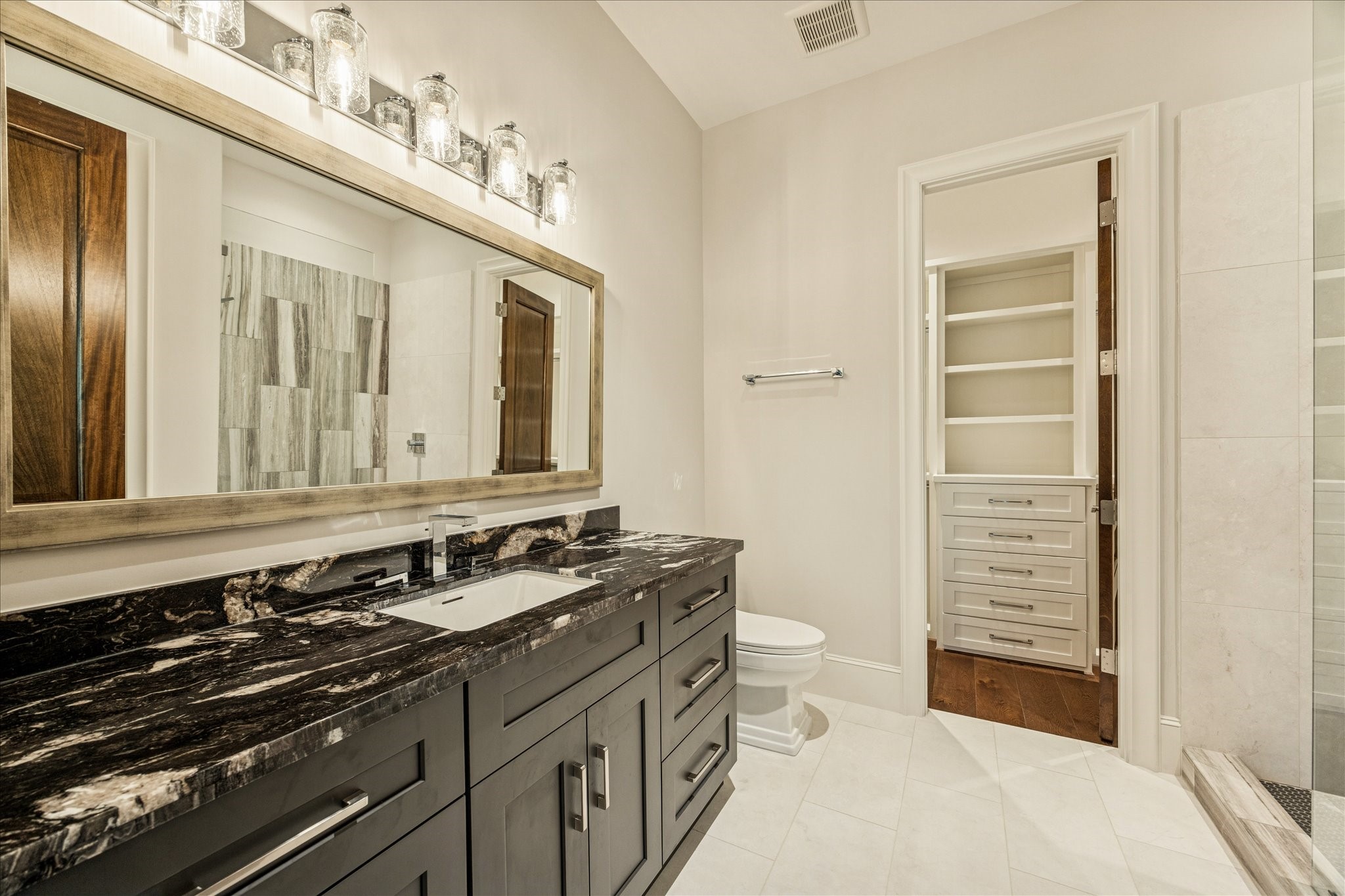 318 Knipp Road Houston, TX 77024 - Photo 32 of 44 a bathroom with a double vanity sink and a mirror