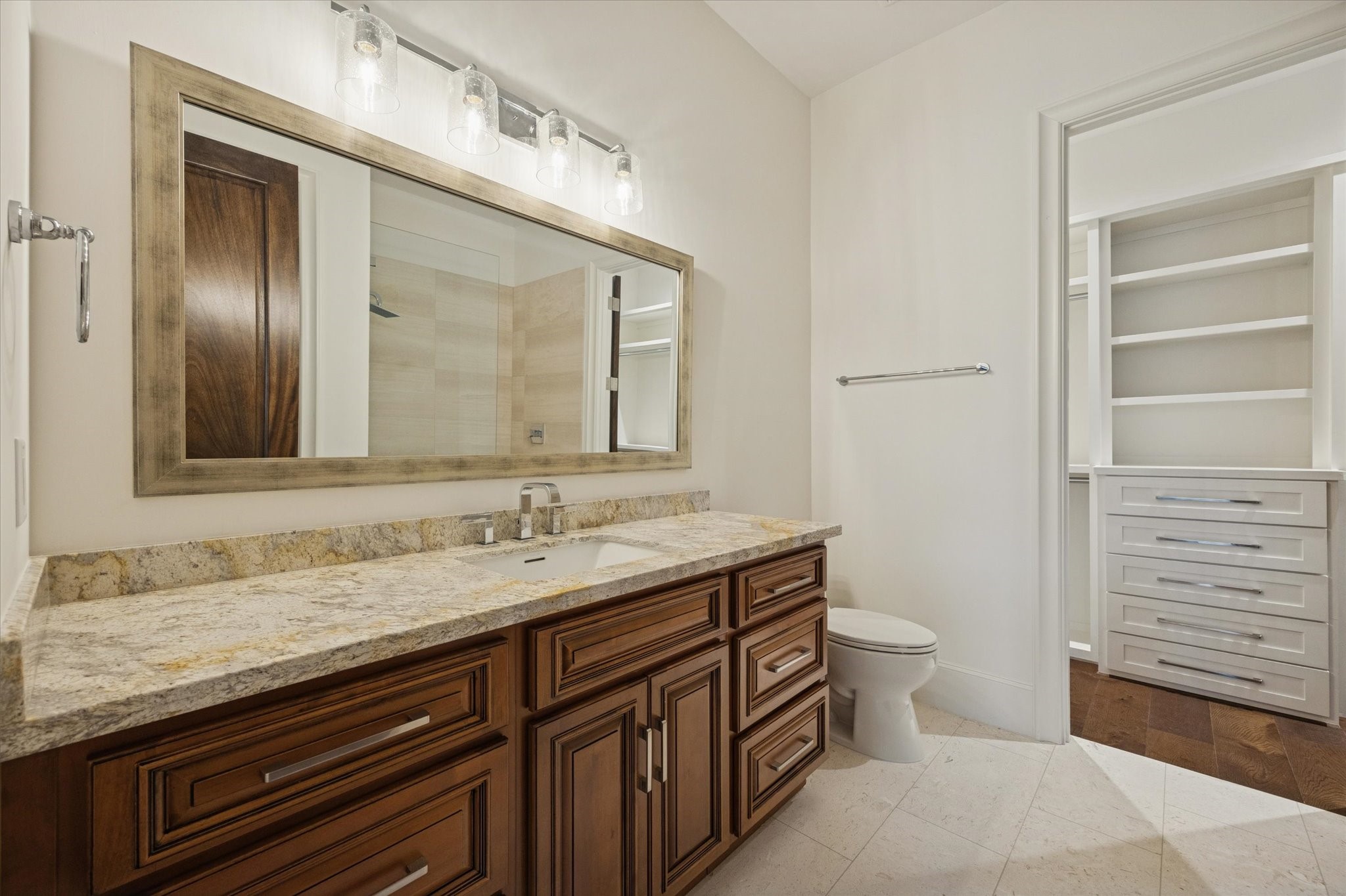 318 Knipp Road Houston, TX 77024 - Photo 33 of 48 a bathroom with a granite countertop sink a toilet and a mirror