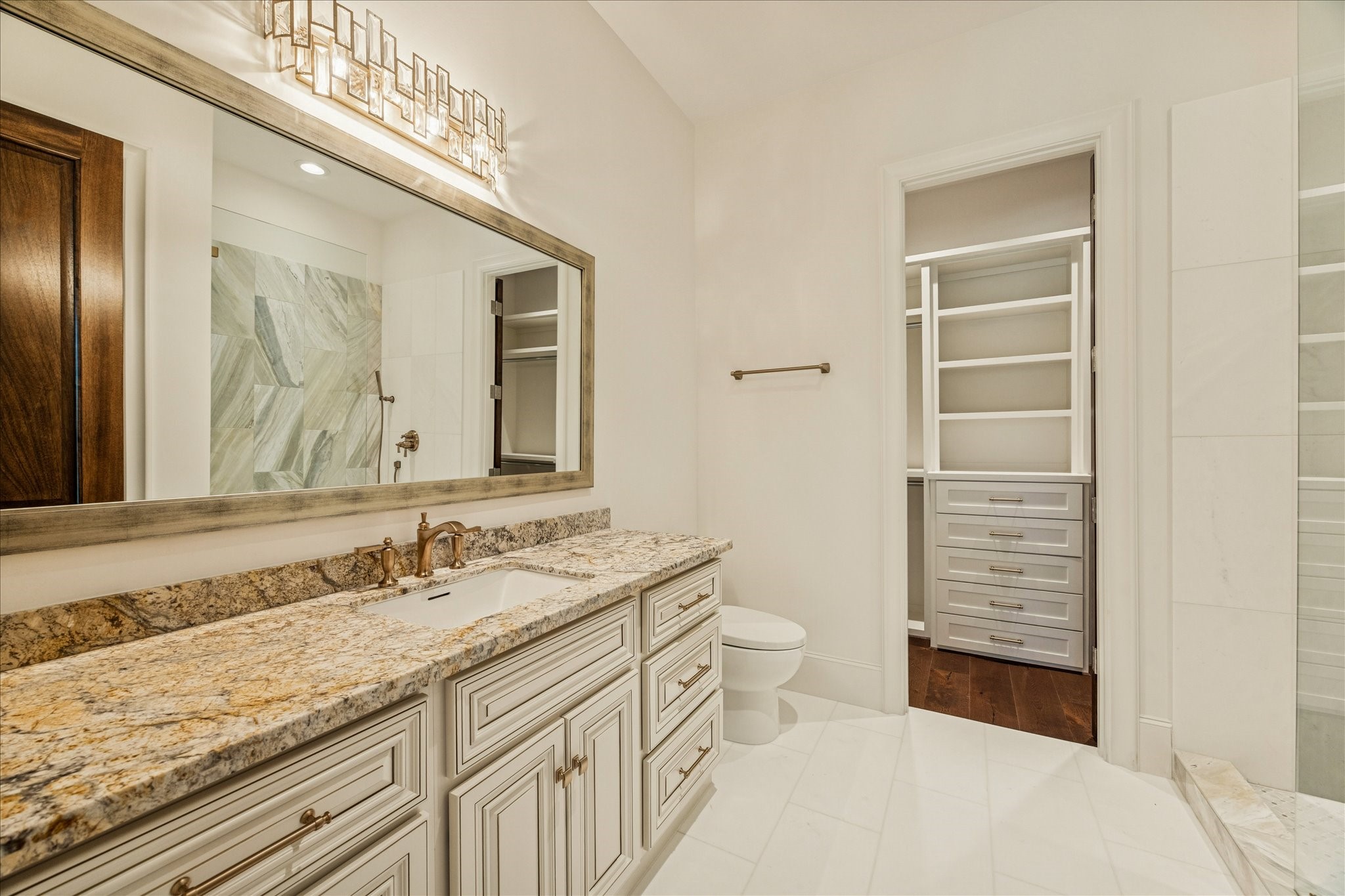 318 Knipp Road Houston, TX 77024 - Photo 34 of 44 a bathroom with a sink a toilet and a mirror