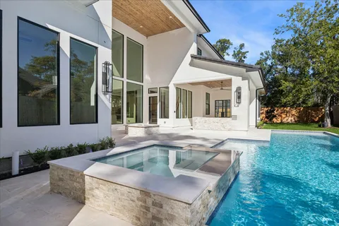 a view of a house with backyard and sitting area
