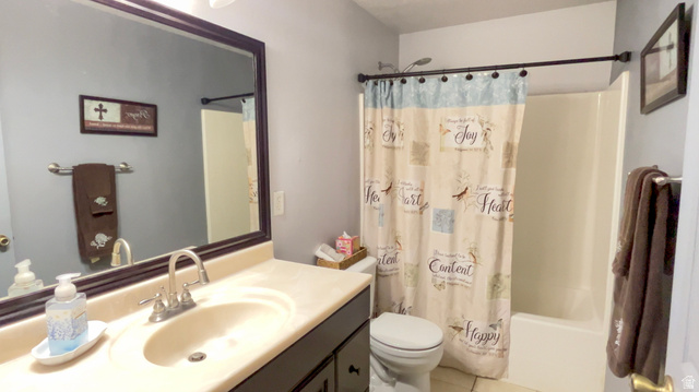 1797 Sunset Road Enoch, UT 84721 - Photo 43 of 80 Bathroom featuring a single vanity with an integrated sink, a rectangular framed mirror, a toilet, and a shower-over-tub combination