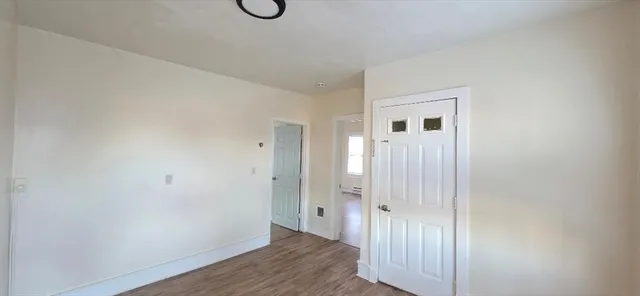 a view of a room with wooden floor