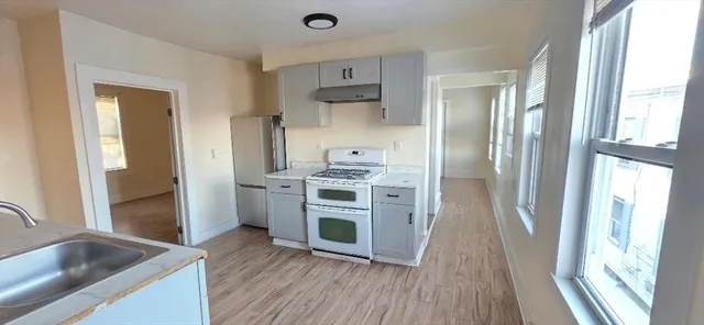 a kitchen with stainless steel appliances granite countertop a refrigerator and a sink