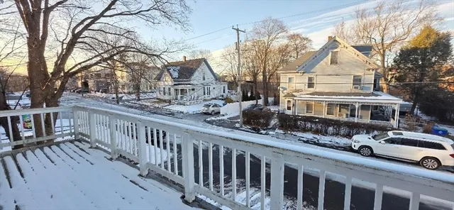 a view of a brick house with wooden fence