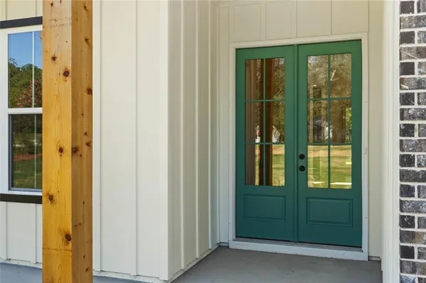 a view of an entryway with wooden floor and door