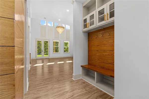 an empty room with wooden floor and a fireplace