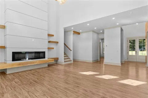 a view of a livingroom with wooden floor and a fireplace