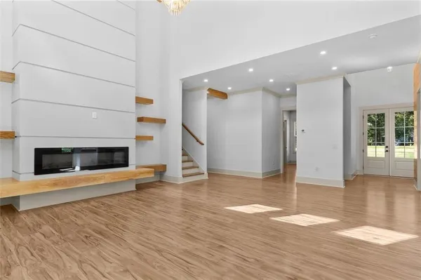 a view of a livingroom with wooden floor and a fireplace