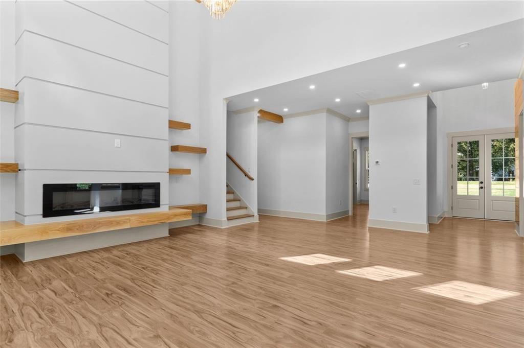 1960 Lost Mountain Road Powder Springs, GA 30127 - Photo 17 of 56 an empty room with wooden floor and a fireplace