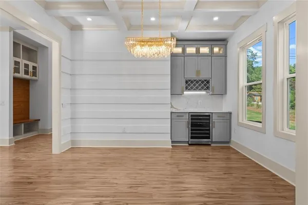 a view of a kitchen with cabinets and wooden floor