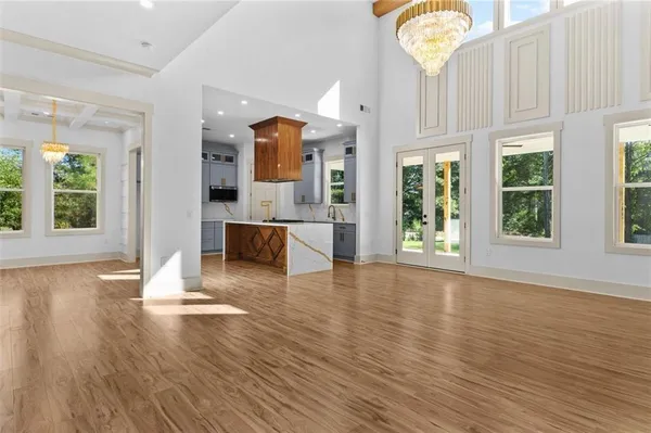 a view of a livingroom with wooden floor and window