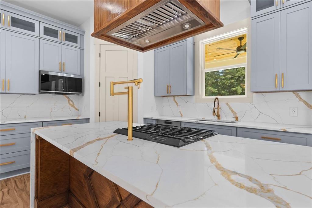 1960 Lost Mountain Road Powder Springs, GA 30127 - Photo 31 of 56 a kitchen with a sink a stove and a refrigerator