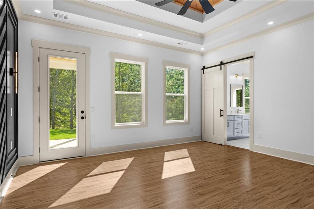 1960 Lost Mountain Road Powder Springs, GA 30127 - Photo 33 of 56 an empty room with wooden floor and windows