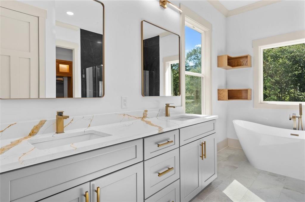 1960 Lost Mountain Road Powder Springs, GA 30127 - Photo 36 of 56 a bathroom with a sink and a bathtub