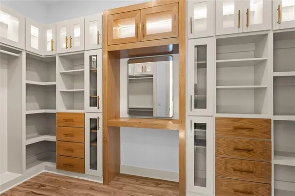 a bathroom with a sink toilet vanity and shower