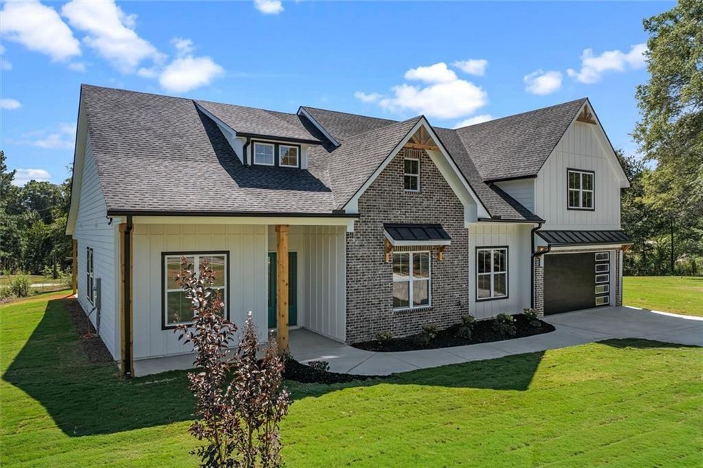 1960 Lost Mountain Road Powder Springs, GA 30127 - Photo 4 of 56 a front view of a house with a yard