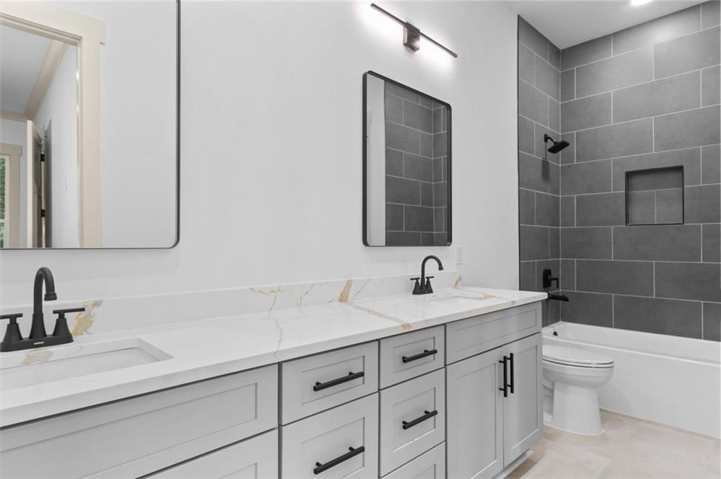1960 Lost Mountain Road Powder Springs, GA 30127 - Photo 43 of 56 a bathroom with a sink and a mirror