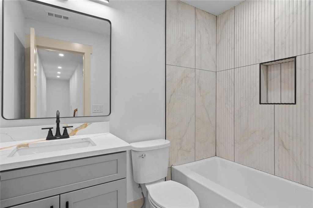 1960 Lost Mountain Road Powder Springs, GA 30127 - Photo 44 of 56 a bathroom with a sink toilet vanity and shower