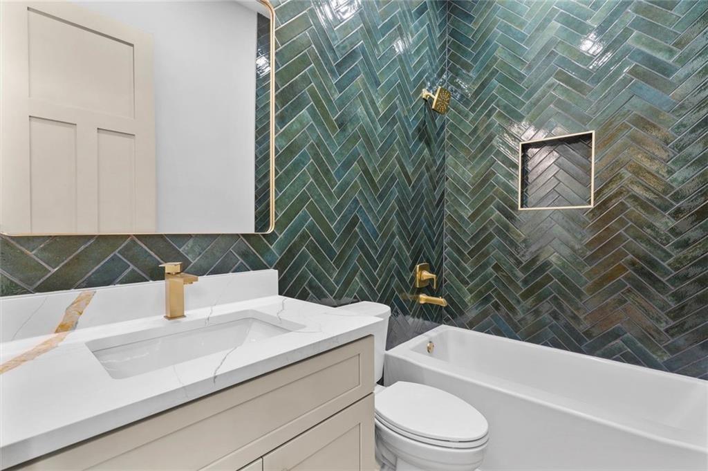 1960 Lost Mountain Road Powder Springs, GA 30127 - Photo 45 of 56 a bathroom with a sink a toilet and bathtub