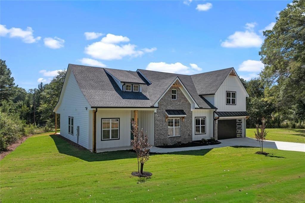 1960 Lost Mountain Road Powder Springs, GA 30127 - Photo 6 of 56 a front view of a house with a yard