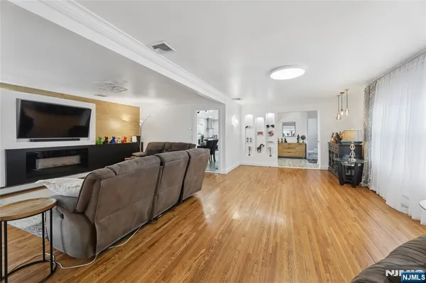 a view of a livingroom with furniture and a flat screen tv