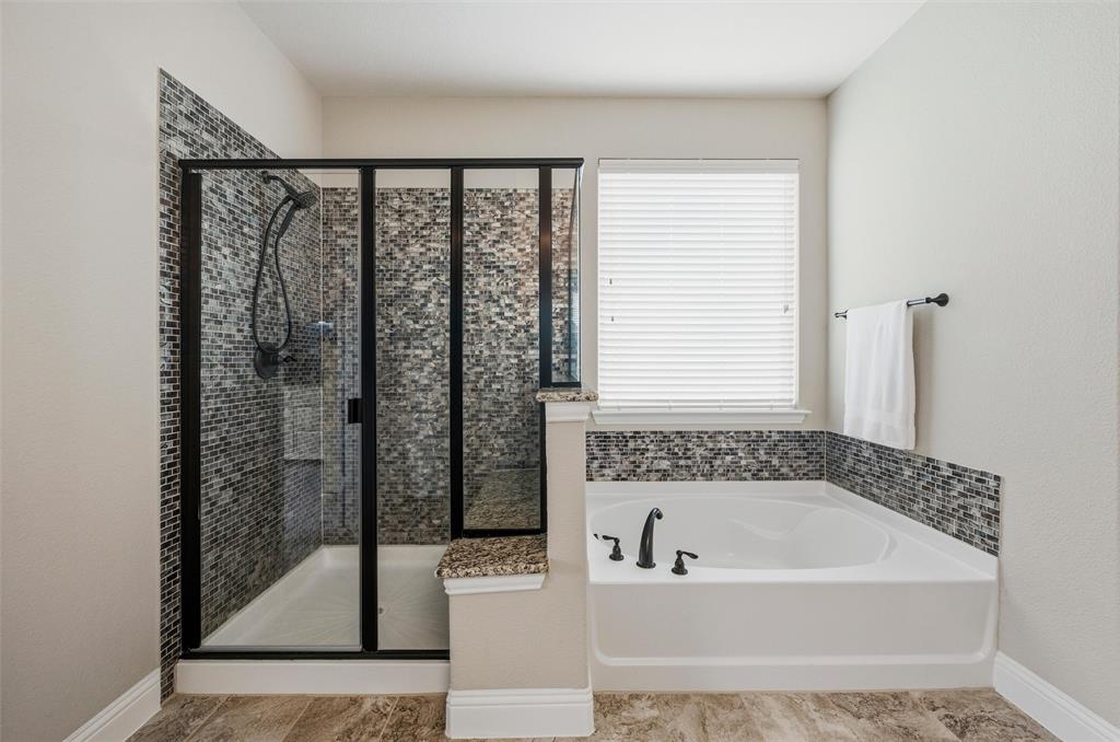 1215 The Trails Drive Blue Ridge, TX 75424 - Photo 21 of 40 Primary Bathroom with Extended Walk in Shower features rainfall shower head and seat.