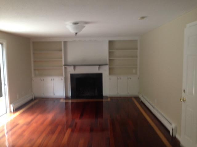 121 Seth Parker Road Centerville, MA 02632 - Photo 3 of 6 a view of empty room with wooden floor and fireplace