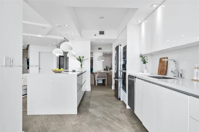 a kitchen with stainless steel appliances and white cabinets